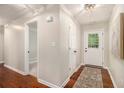 Bright entryway featuring hardwood floors, neutral walls, and a welcoming front door with glass detailing at 215 Nina Circle Cir, Locust Grove, GA 30248