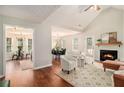 Inviting living room with vaulted ceilings, fireplace, and an open layout to the dining area at 215 Nina Circle Cir, Locust Grove, GA 30248