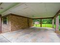 Spacious carport featuring brick columns and access to an enclosed area, perfect for parking and storage at 140 Carriage Cir, Stockbridge, GA 30281