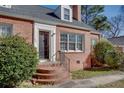 Lovely brick home with black door, detailed trim, and brick steps, offering classic charm and curb appeal at 469 Mellview Sw Ave, Atlanta, GA 30310