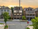 Beautiful street view of a three-story brick home with inviting balconies at sunset at 2111 Bellrick Nw Rd, Atlanta, GA 30318