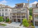 Inviting three-story brick home featuring a two-car garage and multiple balconies at 2111 Bellrick Nw Rd, Atlanta, GA 30318