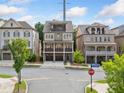 Charming street view of a three-story brick home with balconies on a sunny day at 2111 Bellrick Nw Rd, Atlanta, GA 30318