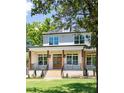 Inviting two-story home boasting a brick porch, wood pillars, and a beautiful green lawn at 2808 Hosea L Williams Dr, Atlanta, GA 30317