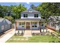 Charming two-story home featuring a brick porch, wood pillars, and a well-manicured lawn at 2808 Hosea L Williams Dr, Atlanta, GA 30317