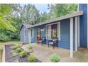 Exterior of light blue home with a covered front porch and nice landscaping at 3076 Montheath Pass, Duluth, GA 30096