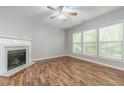 Comfortable living room featuring a fireplace and hardwood flooring at 1346 Upshur Pl, Buford, GA 30519