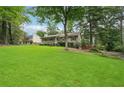 Beautiful property with a sprawling green lawn, mature trees, and a well-maintained exterior at 1952 Winding Creek Sw Ln, Marietta, GA 30064