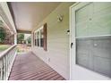 Inviting front porch with wood decking, white railing, and a view of the surrounding greenery at 1952 Winding Creek Sw Ln, Marietta, GA 30064