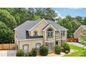 Beautiful two-story home featuring manicured landscaping, neutral stucco facade, and elegant architectural details at 2851 Weatherstone Se Cir, Conyers, GA 30094