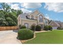 Charming two-story home with a well-maintained lawn, mature trees, and a side-entry garage at 2851 Weatherstone Se Cir, Conyers, GA 30094