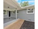 Covered patio with painted brick, outdoor lighting, and wheelchair access ramp at 4477 Timber Ridge Dr, Douglasville, GA 30135