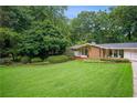 Charming ranch-style home with well-manicured lawn and mature trees at 2072 Castleway Ne Dr, Atlanta, GA 30345