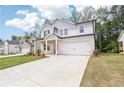 Attractive two-story home with a large driveway, attached garage, and well-manicured lawn, showcasing its curb appeal at 241 Martin Spring, Lawrenceville, GA 30045