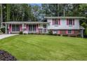 Charming split-level home with a well-manicured lawn and colorful shutters at 2983 Peek Nw Rd, Atlanta, GA 30318