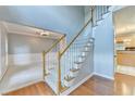 Bright foyer with hardwood floors, a staircase with white railings, and a glimpse into other rooms at 4845 Dartford Dr, Powder Springs, GA 30127