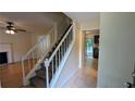 Inviting entryway showcasing a staircase, tile flooring, and a view of the living room at 4927 Millstone Walk, Stone Mountain, GA 30088