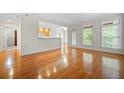 Bright living room featuring hardwood floors, plenty of light, and views to the outside balcony at 50 Biscayne Nw Dr # 2113, Atlanta, GA 30309