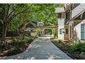 View of the driveway to the covered parking and guest house, enveloped in greenery at 508 Hastings Dr, Peachtree City, GA 30269