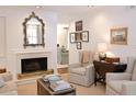 Cozy living room with a fireplace, comfortable seating, and refined decor for relaxation at 40 Olde Ivy Ne Sq, Atlanta, GA 30342