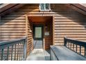 Inviting home entrance featuring a charming welcome sign, wood paneling, and a convenient ramp for accessibility at 451 Wilderness Camp Rd, White, GA 30184