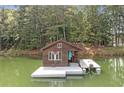 Charming lake house with a wooden exterior, complete with a cozy front deck and a private boat dock at 451 Wilderness Camp Rd, White, GA 30184