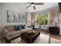 Comfortable living room with neutral tones, stylish decor, and views of lush greenery outside at 123 Ashford Cir, Atlanta, GA 30338