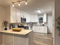 Bright kitchen features white cabinetry, stainless appliances, and granite countertops at 2068 Verbena Nw St, Atlanta, GA 30314