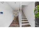 Light-filled entryway features hardwood floors and stairway to the upper level at 215 Morris Ln, Woodstock, GA 30188
