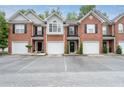 Townhome exteriors showcase brick facades, garages, and dedicated parking at 215 Morris Ln, Woodstock, GA 30188
