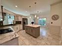 Open kitchen featuring a center island, stainless steel appliances, and tiled floors at 2610 Stokesley Way, Snellville, GA 30078