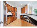 Modern kitchen featuring granite countertops, stainless steel appliances and wood cabinetry at 2828 Peachtree Nw Rd # 2002, Atlanta, GA 30305