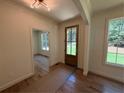 Inviting entryway with natural light, showcasing hardwood floors and a glimpse into the adjacent room at 4110 Post Gate Ct, Cumming, GA 30040