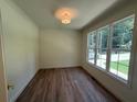Bright office space with hardwood floors and a large window offering natural light and outdoor views at 4110 Post Gate Ct, Cumming, GA 30040