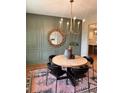Elegant dining area with a round wood table, stylish chairs, and decorative wall accents at 101 Red Oak Ln, Carrollton, GA 30116