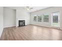 Bright and airy living room with a fireplace, large windows, and a sliding door for outdoor access at 350 Lanier Cir, Woodstock, GA 30189