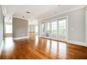 Open-concept living area with hardwood floors, neutral paint, and French doors to the balcony at 3657 Peachtree Ne Rd # 4A, Atlanta, GA 30319