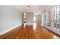 Spacious living room with gleaming hardwood floors, decorative columns and balcony access at 3657 Peachtree Ne Rd # 4A, Atlanta, GA 30319