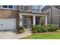 Inviting front porch with decorative columns and a stylish front door at 3860 Oxford Park Ln, Cumming, GA 30040