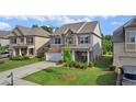 Landscaped front yard with a well-maintained lawn and mature tree at 3860 Oxford Park Ln, Cumming, GA 30040