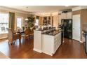 Open concept kitchen with granite countertops, stainless steel appliances, and an island sink at 5110 Mulberry Pass Ct, Hoschton, GA 30548