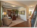 Inviting home office space featuring built-in bookcase, desk, and cozy seating area at 5110 Mulberry Pass Ct, Hoschton, GA 30548