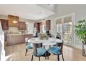 Charming dining area with hardwood floors and access to a patio makes for a bright and inviting place for Gathering gatherings at 150 Ray Way, Chattahoochee Hills, GA 30268
