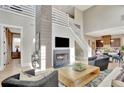 Stunning living room with high ceilings, stone fireplace, and open floor plan offers a modern and spacious entertaining area at 150 Ray Way, Chattahoochee Hills, GA 30268