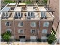Aerial view of brick townhomes featuring rooftop terraces, garages, and well-maintained exterior facades at 422 Bill Kennedy Se Way, Atlanta, GA 30316