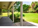 Covered patio showing a vast and lush backyard with plenty of greenery at 5427 Highway 81, Loganville, GA 30052