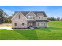 Beautiful two-story home featuring mixed material facade, a well-manicured lawn and inviting curb appeal at 102 Red Oak Ln, Carrollton, GA 30116