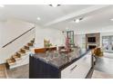 Bright kitchen with a marble countertop island overlooking the living area and fireplace at 1767 Defoor Nw Ave # D, Atlanta, GA 30318