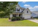 Traditional two-story home with an attached two-car garage, complemented by a neatly maintained lawn and landscaping at 27 Autumn Canyon Se Path, Cartersville, GA 30121