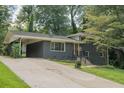 Charming one story home with a dark gray brick exterior, car port, and landscaped front yard at 2524 Glenrock Dr, Decatur, GA 30032